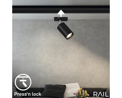 Schwarzer Schienenstrahler an einer Schiene mit ''Press''n lock'' Symbol