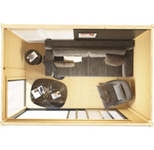 Vue intérieure d'une maison en bois avec canapé, fauteuil et tables