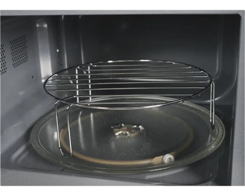 Intérieur d''un micro-ondes avec plateau tournant et grille