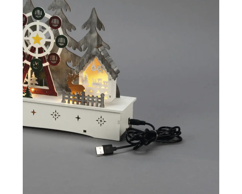 Dekorative LED-Leuchte mit Weihnachtsmotiv, darunter ein Riesenrad, ein Haus, Bäume und ein Hirsch