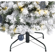 Gros plan sur un sapin de Noël artificiel enneigé avec décorations