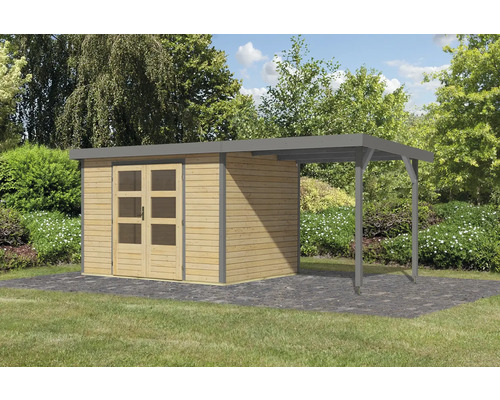 Abri de jardin avec annexe sur pelouse devant des arbres