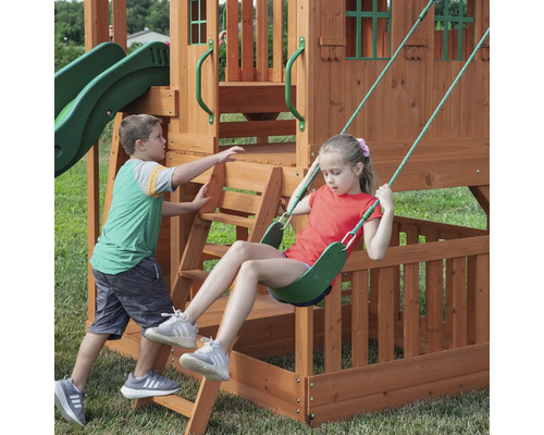 Kinderschaukel mit Rutsche und Leiter auf einem Spielplatz