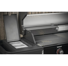 Vue détaillée d''un barbecue à gaz noir avec grille de maintien au chaud et récipients