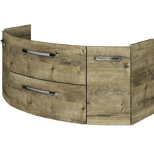 Gebogener Waschbeckenunterschrank in Eiche-Optik mit drei Auszügen und verchromten Griffen.