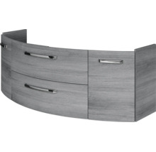 Geschwungener Waschbeckenunterschrank in Holzoptik mit zwei Schubladen und einer Tür inklusive Metallgriffen.