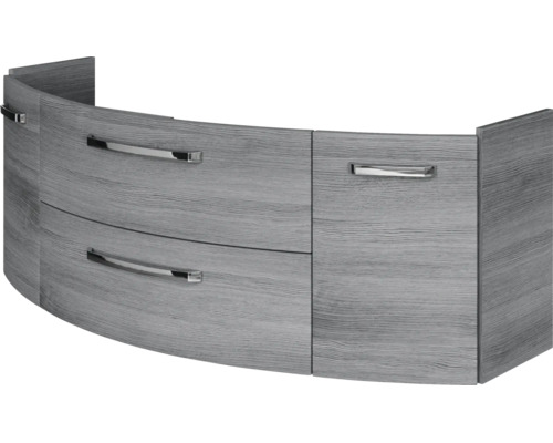 Geschwungener Waschbeckenunterschrank in Holzoptik mit zwei Schubladen und einer Tür inklusive Metallgriffen.