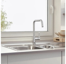 Küchenspüle mit Armatur vor einem Fenster