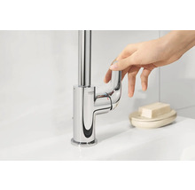Robinet de lavabo brillant avec mitigeur monocommande et logo Grohe actionné par une main.