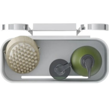 Aufsicht auf eine Duschablage mit Massagebürste und Seifenspender