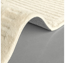 Tapis beige avec texture tissée et bord roulé