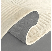 Vue détaillée d'un tapis beige avec motif géométrique