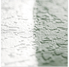 Gros plan d'un mur avec une texture d'enduit gratté