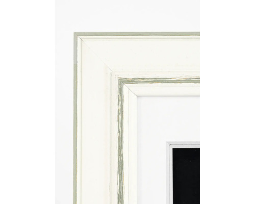 Détail d'un cadre photo blanc avec un léger aspect usagé