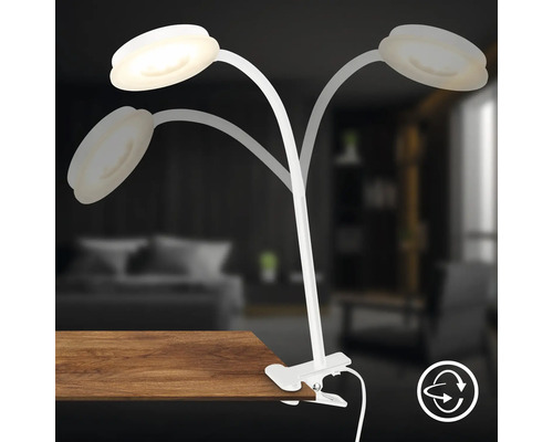Klemmleuchte mit drei Armen und LED-Leuchten an einem Tisch