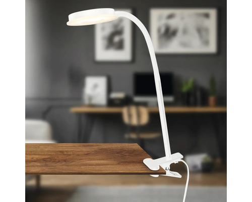 Weisse Klemmleuchte auf einem Holztisch, geeignet für Arbeitsbereiche
