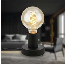 Dekorative Tischleuchte mit Glühbirne auf schwarzem Sockel