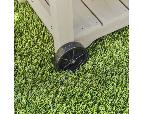 Gros plan d''un chariot roulant en bois avec une roue noire sur une pelouse