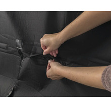 Schutzhülle mit Reissverschluss wird von Händen geschlossen