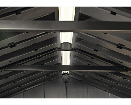 Vue intérieure d'un abri de jardin avec chevrons et éclairage