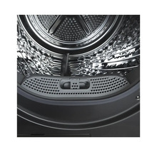 Vue intérieure d'une machine à laver avec tambour et filtre à peluches