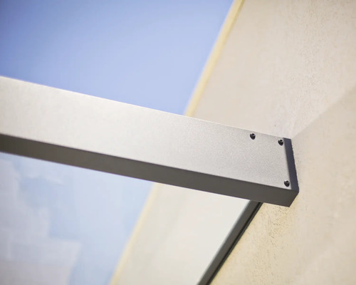 Fixation murale d'un support d'auvent en verre en aluminium avec vis apparentes.