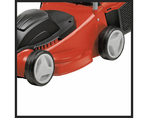 Gros plan d'une tondeuse à gazon rouge avec des éléments noirs et blancs.