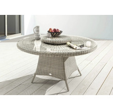 Table de jardin ronde en rotin avec plateau en verre, vaisselle et corbeille de fruits