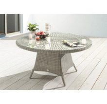 Table de jardin ronde avec plateau en verre, structure en rotin et décoration