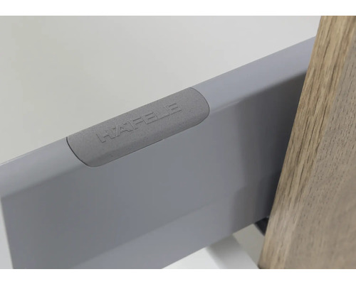 Metall-Schubladenzarge mit Häfele Logo auf der Abdeckkappe.