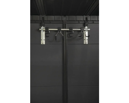 Support à vélos sur un mur de cabanon de jardin gris