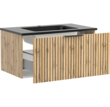 Waschtischunterschrank mit integriertem dunklen Waschbecken und Front in Holzoptik mit vertikalen Lamellen, Schublade leicht geöffnet.