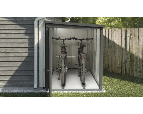 Box à vélos avec deux vélos dans le jardin.