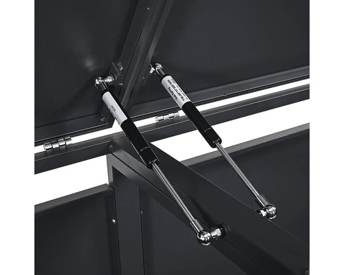 Deux vérins à gaz sur un coffre de rangement en métal pour soutenir le couvercle.