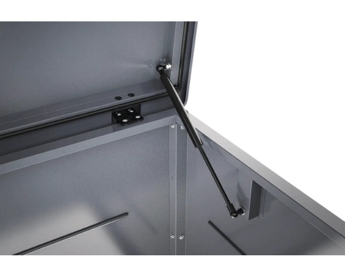 Détail du vérin à gaz sur un coffre de jardin en métal pour faciliter l'ouverture et le maintien du couvercle.