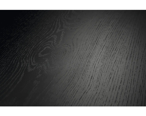 Vue rapprochée d'une surface noire à l'aspect bois avec veinure et texture marquées.