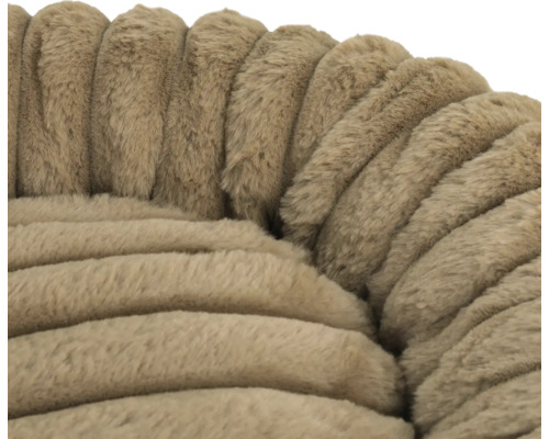 Gros plan d'un matériau doux et pelucheux à structure côtelée en beige pour un panier pour animaux.