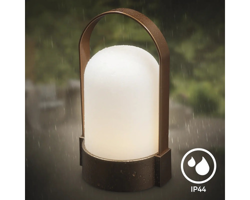 Lampe d'extérieur portable avec poignée en arc et diffuseur mat, protégée contre les projections d'eau selon l'indice de protection IP44.