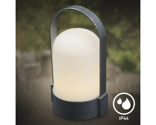 Lampe d'extérieur LED portable avec poignée et indice de protection IP44, adaptée à une utilisation sous la pluie.