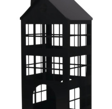 Photophore noir en métal en forme de maison avec de nombreuses découpes de fenêtres.