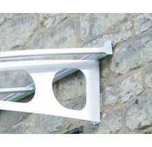 Support blanc pour marquise de porte avec découpes circulaires fixé sur un mur en pierre.