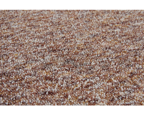 Surface de tapis texturée avec motif chiné en brun et beige.