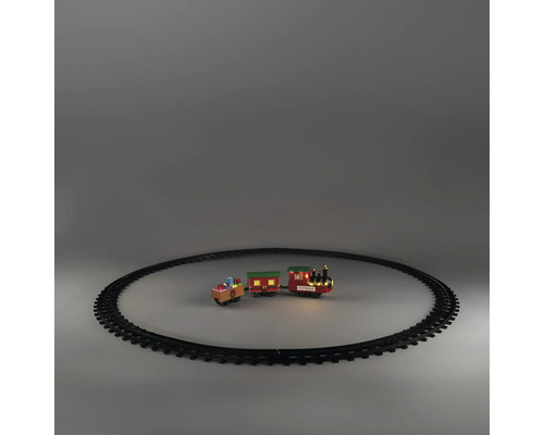 Train de Noël avec locomotive, deux wagons et rails circulaires. Locomotive avec éclairage LED et inscription Express.