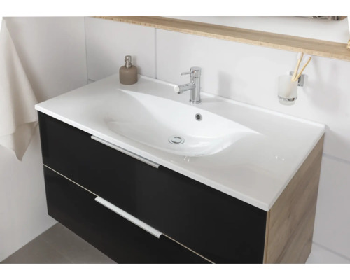 Meuble sous-vasque moderne avec façade foncée, côtés en aspect bois, vasque en céramique blanche et robinetterie chromée.