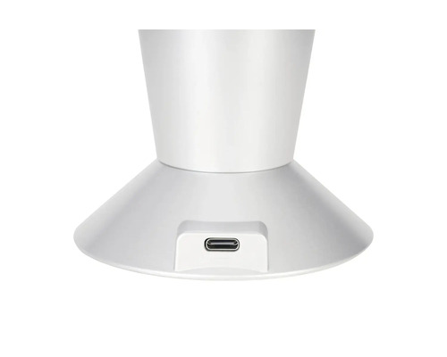 Port de charge USB-C sur le socle d'une lampe blanche.