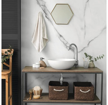Salle de bain moderne avec vasque ronde, robinet haut, console en bois, miroir hexagonal et mur en marbre.