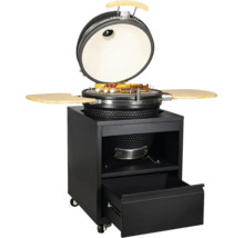 Gril Kamado en céramique avec couvercle ouvert sur un chariot métallique mobile avec tiroir et tablettes latérales en bois.