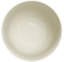 Vue intérieure d'un pot de fleurs rond en plastique avec elho Logo et symbole 100 pour cent recyclable.