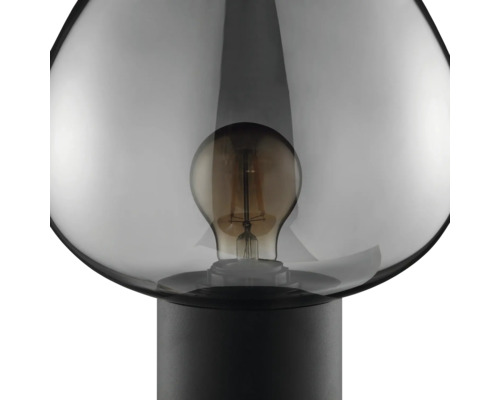 Lampe de table moderne avec abat-jour en verre et ampoule visible sur un socle rond simple.