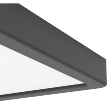 Gros plan sur l'angle d'un plafonnier à panneau LED carré avec un cadre gris foncé mat.
